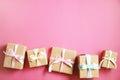 Rustic composition w/ bunch of beautiful presents in craft paper wrapping. Close up of many gifts in brown wrap with ribbon & bow.