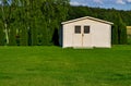 New garden house or shed in green lawn or grass