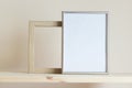 Simple composition with two frames silver and wooden frames on yellow background Royalty Free Stock Photo