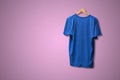 a simple cotton t-shirt on the hanger hang on the wall, abstract clothes with copy space