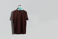 a simple cotton t-shirt on the hanger hang on the wall, abstract clothes with copy space