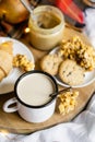 Simple country home breakfast in bed, coffee with milk and homemade pastry on plaid blanket Royalty Free Stock Photo