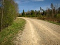 A simple country road, the first bright spring greenery, the first leaves in the trees Royalty Free Stock Photo
