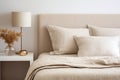 Simple cozy beige bedroom interior with bed headboard, linen bedding and bedside table. Generative AI Royalty Free Stock Photo