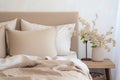 Simple cozy beige bedroom interior with bed headboard, linen bedding and bedside table. Generative AI Royalty Free Stock Photo