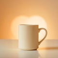 A simple cream colored mug sits on a white surface with a blurred heart shape in the background light Royalty Free Stock Photo