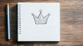 Simple Crown Sketch on Lined Notebook Page,  A Hand Drawn Crown Symbol on a Notepad,  A Graphic Design of a Crown on a White Royalty Free Stock Photo