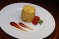 Simple cup rice decoration with tomato sauce and make tomato flower on white plate on table Royalty Free Stock Photo