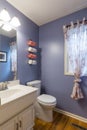 Simple cute bathroom interior with purple walls in Kansas City, Missouri, USA