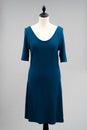 Simple, dark blue dress displayed on a white, headless mannequin Royalty Free Stock Photo