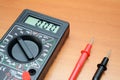 Simple digital electronic multimeter on brown background Royalty Free Stock Photo
