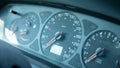 A simple dusty old speedometer in a generic motionless stopped car interior, object detail, closeup, vehicle dashboard dials