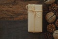 Simple eco friendly gift boxes package wrap with brown paper in old wooden table background, green present concept