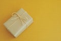 Simple eco friendly gift boxes package wrap with brown paper in old wooden table background, green present concept