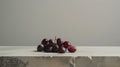 the simple elegance of a minimalist table adorned with a carefully arranged cluster of dates, their rich color contrasting with