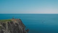 Simple elegance: tropical blue beach scene with rocks and a solitary boat Royalty Free Stock Photo