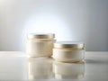 Simple Elegance Two Empty Cream Jars on a Pristine White Table A Study in Clean Lines and Natural Royalty Free Stock Photo