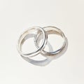 Simple elegance of two overlapping silver wedding rings Royalty Free Stock Photo
