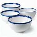 Elegant stack of ceramic bowls with navy blue rim detail showcasing refined design on white background Royalty Free Stock Photo