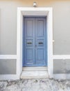 A simple yet elegant house entrance bluish grey painted door in downtown Athens.