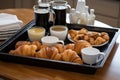 simple and elegant tray of pastries, croissants, and coffees
