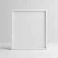A simple, empty white square picture frame rests against a plain white background. Royalty Free Stock Photo