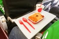 Simple in-flight meal of rice, meat, coffee in disposable utensils Royalty Free Stock Photo