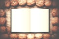 Simple frame arranged from walnuts on wooden background with ope