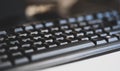 Simple generic black business office computer keyboard object detail, shallow dof, closeup, nobody. Abstract background, no people