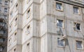 Simple generic new real estate building left unfinished, detail, block of flats, raw concrete walls, windows. Construction site