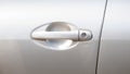 Simple generic silver car door handle with a key lock hole, side front view, object detail, closeup, vehicle doors handle frontal Royalty Free Stock Photo