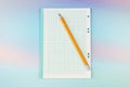 Simple graphite pencil on blank sheet of checkered notebook. School notebook with pencil on desktop Royalty Free Stock Photo