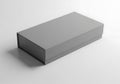 A simple gray rectangular box rests on a plain white surface with subtle shadow Royalty Free Stock Photo