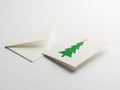 Simple green christmas tree card with envelope on white background Royalty Free Stock Photo