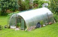 Simple greenhouse filled with different species of plants and vegetables