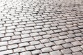 Simple grey convex square stone pavement surface, paving, causeway outdoors background texture, light reflections sidewalk Royalty Free Stock Photo
