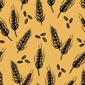 Simple hand drawn black wheat stalks and seeds on a warm yellow background creating a vibrant seamless pattern Royalty Free Stock Photo