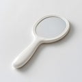 Simple Hand Mirror Displayed Against a Plain White Background in a Clean, Minimalistic Style Emphasizing Elegance and Everyday Royalty Free Stock Photo