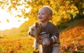 Simple happiness. Sweet childhood memories. Child play with yorkshire terrier dog. Toddler boy enjoy autumn with dog