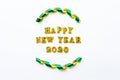 Simple happy new years 2020 text in gold lettering and curled ribbon isolated on white background