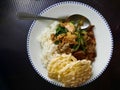 A simple home-made dinner delicious Asian food. It consists of white rice, chicken, stir-fried vegetables, and Krupuk. Royalty Free Stock Photo