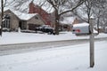 Home Mailbox along a Snow Covered Neighborhood Street with Homes during a Snowfall in Suburban Illinois