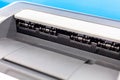 Simple home office laser printer extreme closeup, output tray macro, tray and rolls detail shot, office workspace equipment Royalty Free Stock Photo