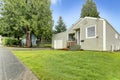 Simple house exterior. View of entrance porch and front yard