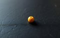Single Yellow Chickpea on Slate Royalty Free Stock Photo