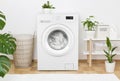 Simple interior of home laundry room with modern washing machine Royalty Free Stock Photo