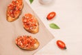 Simple italian appetizing bruschetta with tomato, on wooden table