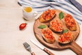 Simple italian appetizing bruschetta with tomato, on wooden table