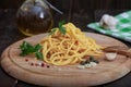 Simple italian spaghetti with olive oil and ingredients on wooden board