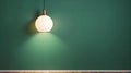 Simple lamp hangs on green wall and illuminates it, space for te